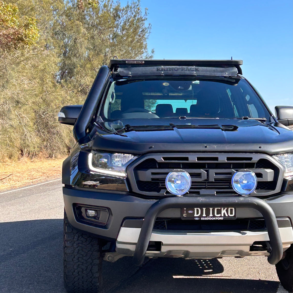 Black Ford Ranger Raptor PX3 front view with light bar and Canna Fabrication short-entry stainless snorkel