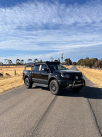 Black Ford Ranger Raptor PX3 on the road showing Canna Fabrication stainless snorkel — rear three-quarter view
