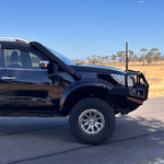 Black Nissan Navara NP300 side view showing Canna Fabrication short-entry stainless snorkel on the A-pillar