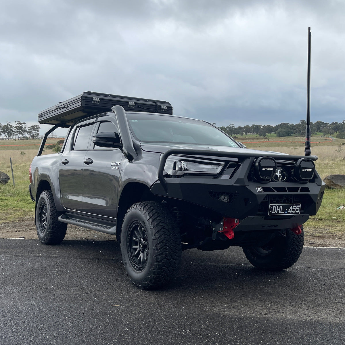 Grey Toyota Hilux N80 tourer with rooftop tent and Canna Fabrication short-entry stainless snorkel