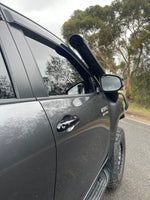Canna Fabrication stainless snorkel on a grey Toyota Hilux N80 — A-pillar detail