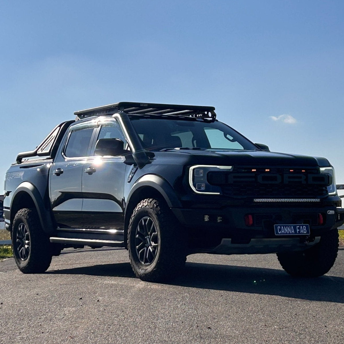 Black Ford Next-Gen Ranger Raptor with roof platform and Canna Fabrication stainless snorkel — front three-quarter view